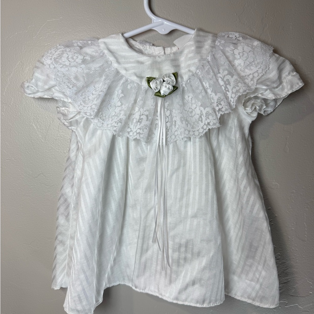 white vintage baby girl christening dress with lace trim